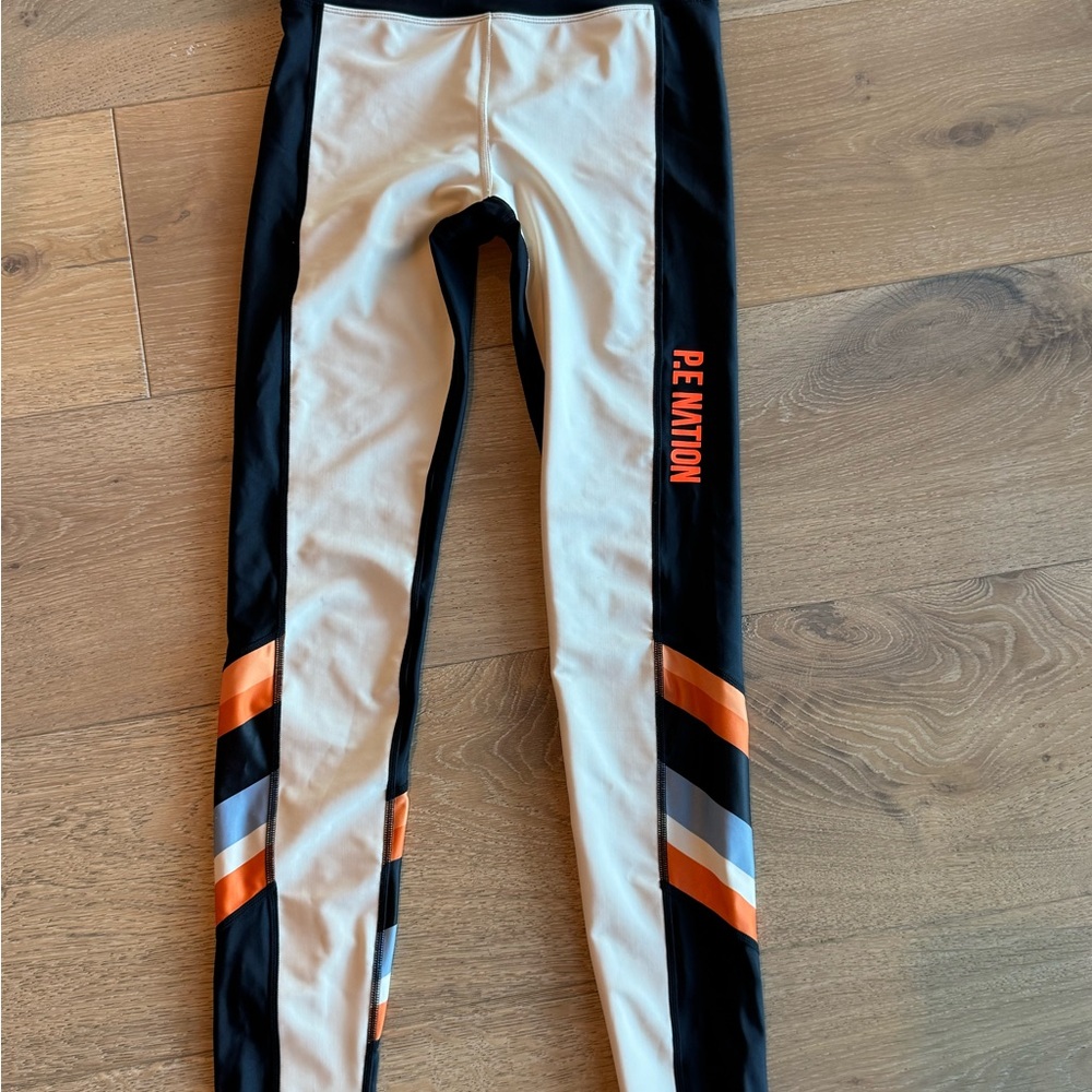P.E Nation Cream and Black Leggings with Vibrant Orange Details